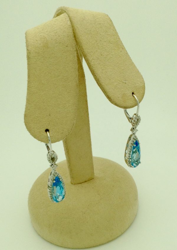 7.00 Ct Blue Topaz with 0.76 Ct Diamond Short Drop Earrings 14k hanging on carton ears