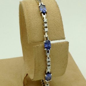 3.50 Ct Unheated Sapphire and 0.72 Ct Diamond Cocktail Tennis Bracelet 14k hanging on a piece of carton