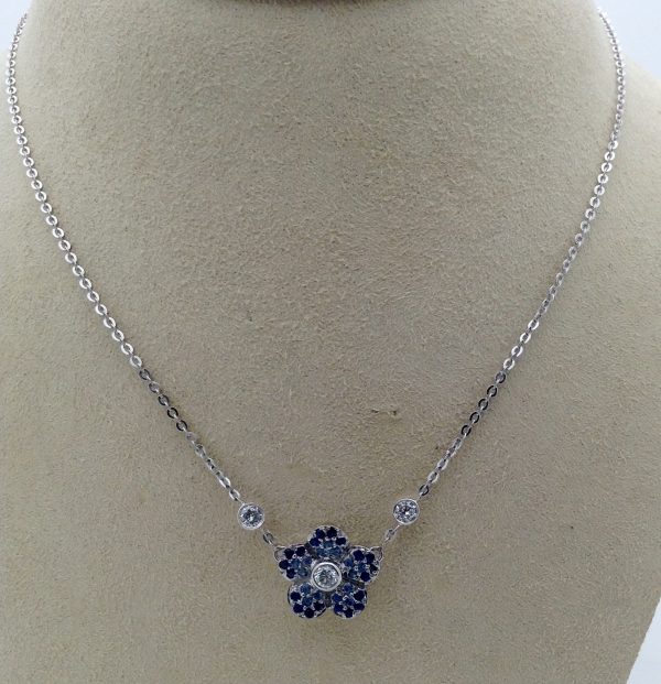 0.96 Ct Diamonds and 0.38 Sapphire Flower Cluster Necklace 14k on a carton neck