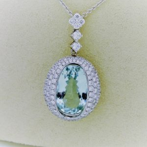 27.00 carat Aquamarine and 2.40 carat Diamond Triple Halo Necklace on a carton neck