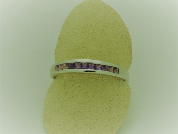 0.25 carat Amethyst Princess Cut Channel with14k Gold Ring on a carton finger