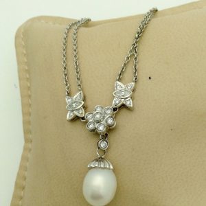 1.00ct VS Diamond 14k White Gold Cluster Necklace w/ 11mm South Sea Pearl hanging on a pillow