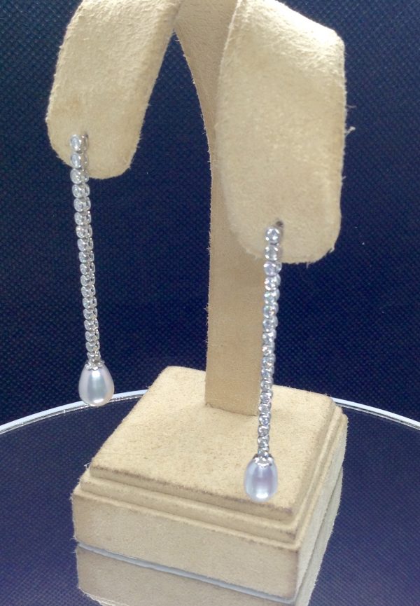 10mm South Sea Pearl Drops with 1.00 Ct Diamond Long Drop Dangle 18k White Gold Earrings hanging on fake ears