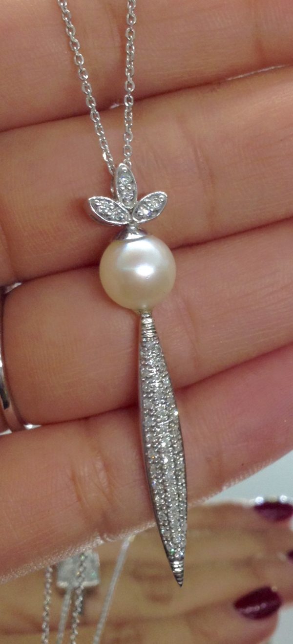 Holding a 14k White Gold Necklace 8.5 mmSouth Sea Pearl with 1.00 Ct Diamond Design with 14k Chain