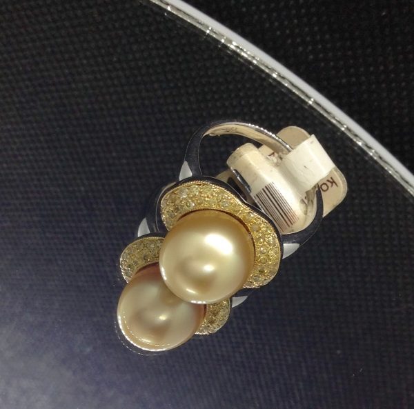 Flamboyant 12mm Golden South Sea Pearl with 0.74 Ct Canary Diamonds 18k White Gold Ring on a piece of glass