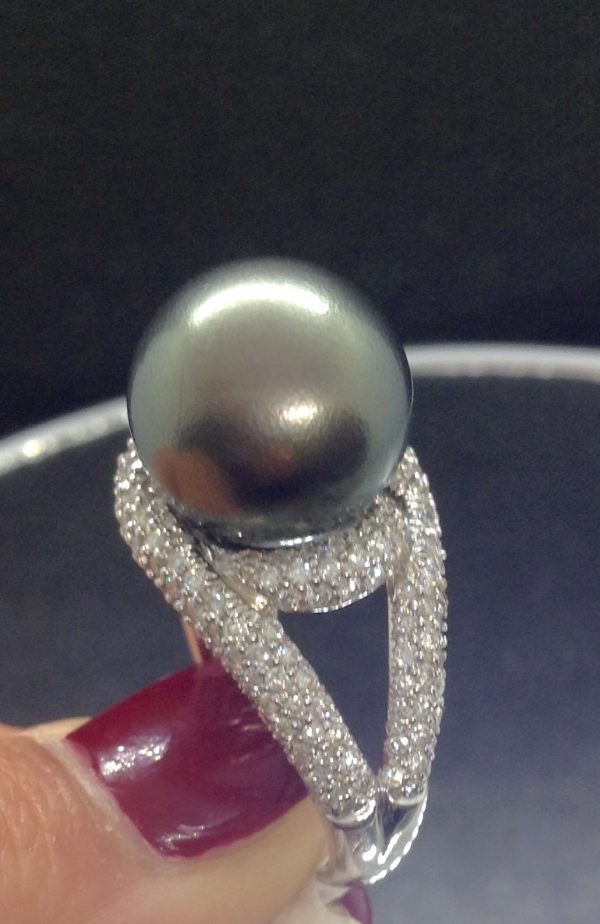 A woman holding a Magnificent 12mm Tahitian Pearl with 1.40 Ct Diamond 18k White Gold Ring (side view)