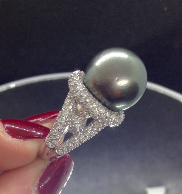 A woman holding a Magnificent 12mm Tahitian Pearl with 1.40 Ct Diamond 18k White Gold Ring