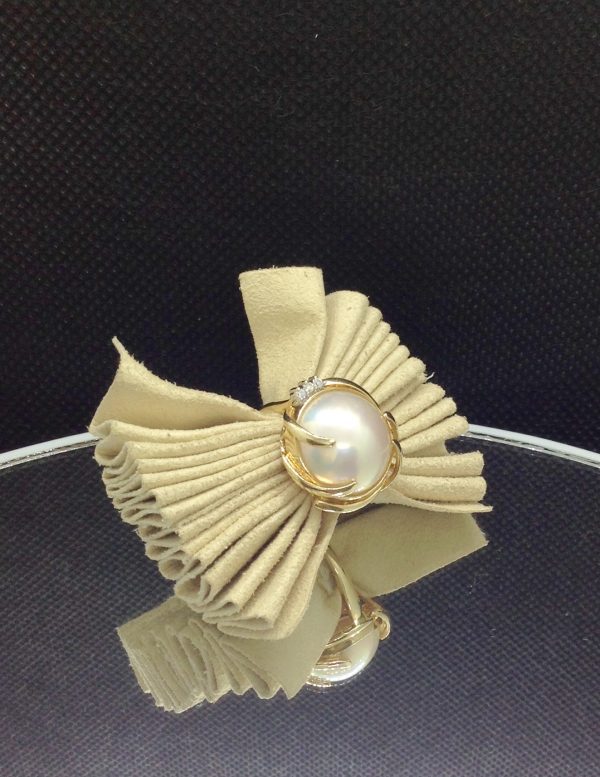 Alluring 13mm Mabe Pearl with 0.03 Ct Diamond Accents 14k Yellow Gold Ring on a piece of glass