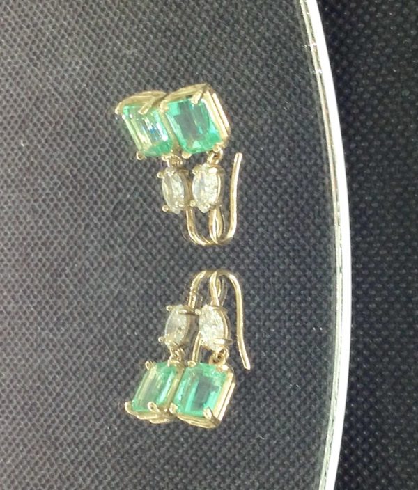 5.00 Ct Colombian Emerald with 0.50 Ct Diamonds 14k Yellow Gold Short Drop Earrings on a piece of glass