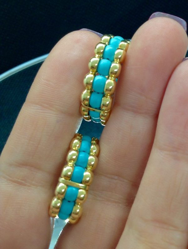 A woman holding Unique 14k Yellow Gold Hoops with 2.65 Ct Turquosie