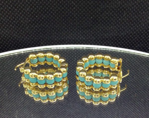 Unique 14k Yellow Gold Hoops with 2.65 Ct Turquosie on a piece of glass