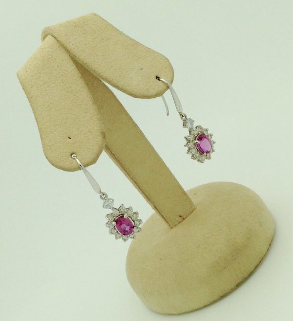 14K White Gold 2.0 CT Pink Sapphire Flower Earrings W/ 1.04 CT VS Diamond Halo hanging on fake ears