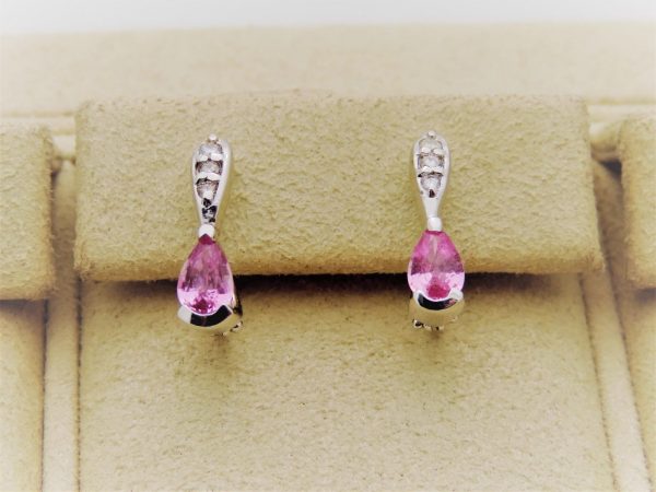 14K White Gold 0.15 Ct Diamond & 0.60 Ct Pink Topaz Short Drop Earrings on a piece of cloth