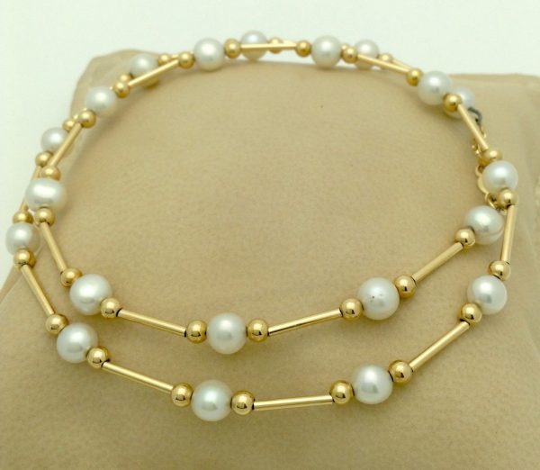 Classy 4mm Akoya Pearls w/ 14k yellow gold beads and bars on a pillow