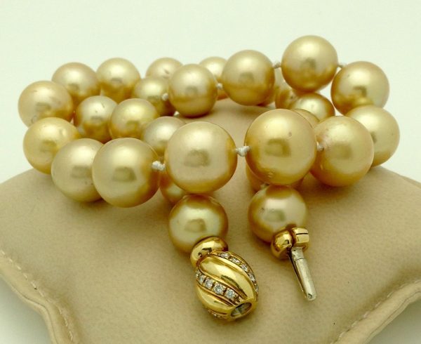 Golden South Sea Pearls 16mm 18k Yellow gold Clasp w/ VS Diamonds accents on a pillow
