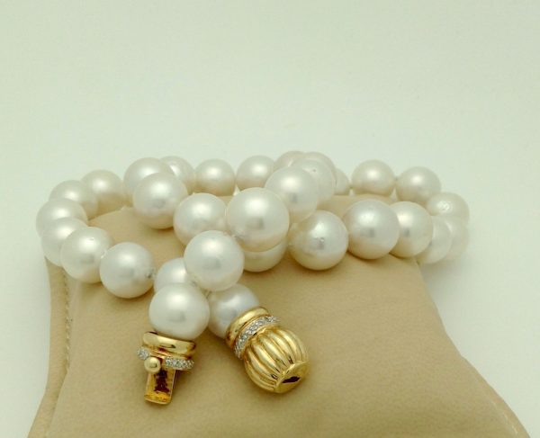 South Sea Cultured Pearls 13mm 18k Yellow Gold Clasp w/ VS Diamonds accents on a pillow