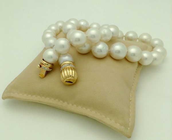 South Sea Cultured Pearls 13mm 18k Yellow Gold Clasp w/ VS Diamonds accents on a pillow