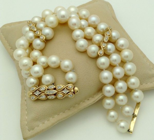 3 Row South Sea Cultured Pearls 8mm 18k Yellow Gold Clasp w/ VS Diamonds accents on a pillow