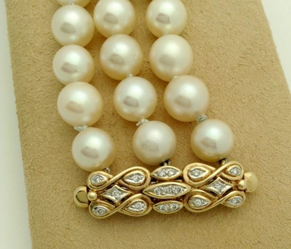 A woman holding 3 Row South Sea Cultured Pearls 8mm 18k Yellow Gold Clasp w/ VS Diamonds accents from close up