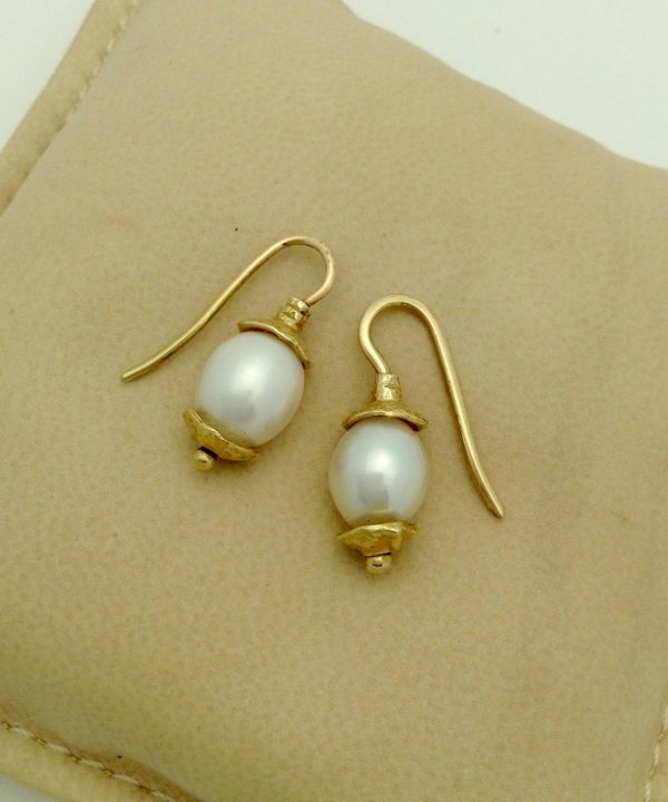 Two Short Drop South Sea Cultured 10mm Pearls w/ 14k Yellow Gold Rustic Accents on a pillow