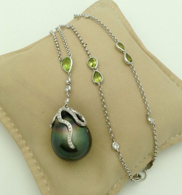 Tahitian Pearl w/ Peridot Accents & 1.00 CT VS Diamonds 14k White Gold Necklace on a pillow