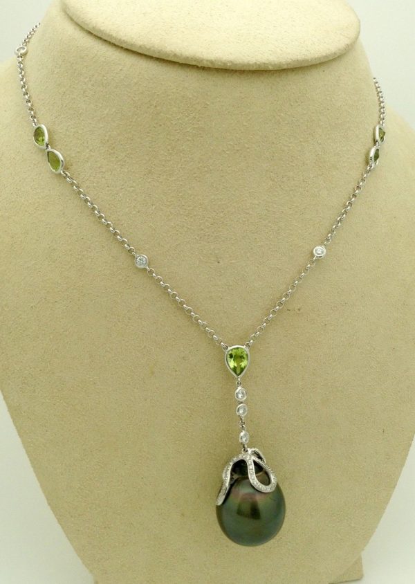 Side view of Tahitian Pearl w/ Peridot Accents & 1.00 CT VS Diamonds 14k White Gold Necklace on a fake neck