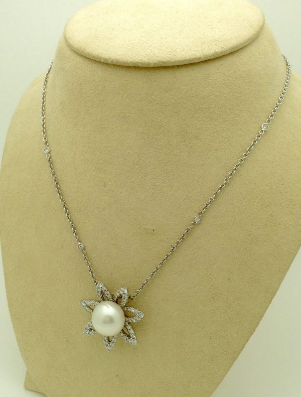 Side view of 2.0 CT VS Diamond Flower w/ 11m South Sea Pearl & Diamond by the yard 18k Chain hanging on a fake neck