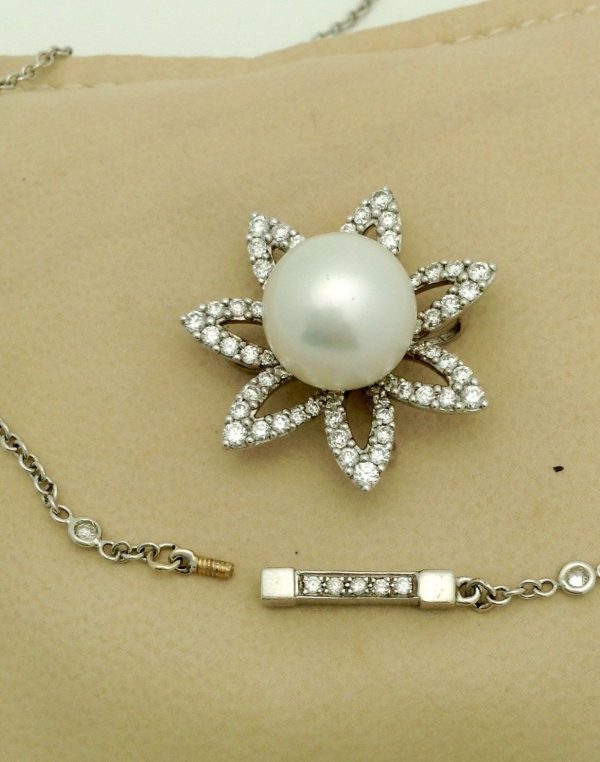2.0 CT VS Diamond Flower w/ 11m South Sea Pearl & Diamond by the yard 18k Chain hanging on a pillow