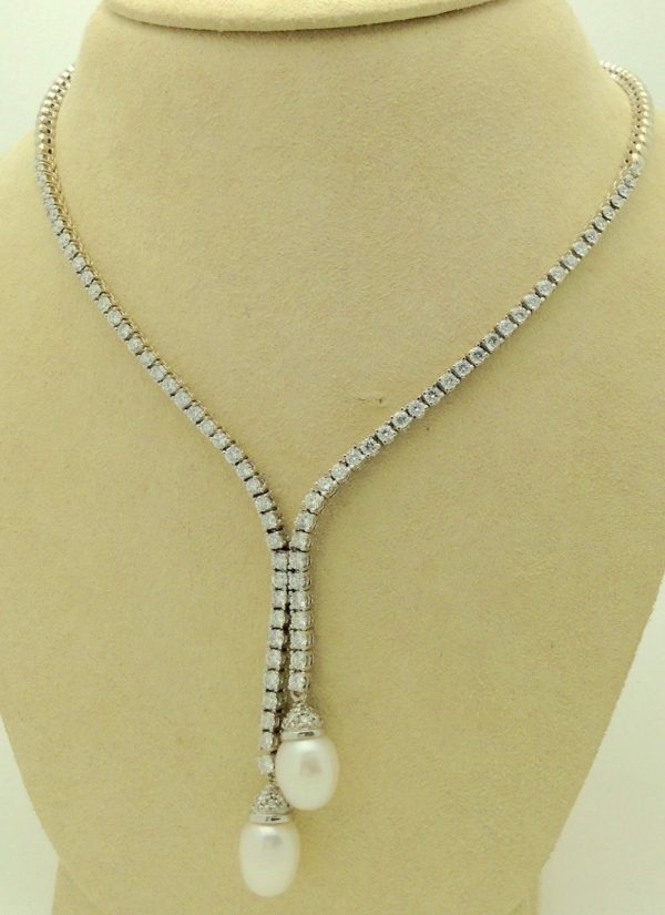 Front view of 4.50ct VS Diamond 18k White Gold Tennis Necklace w/ 11mm South Sea Pearls hanging on a fake neck