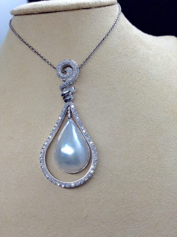 18.7 Ct Mabe Pearl with 1.00 Ct Diamond 14k White Gold Pendant with 16" 14k White Gold Chain hanging on a fake neck