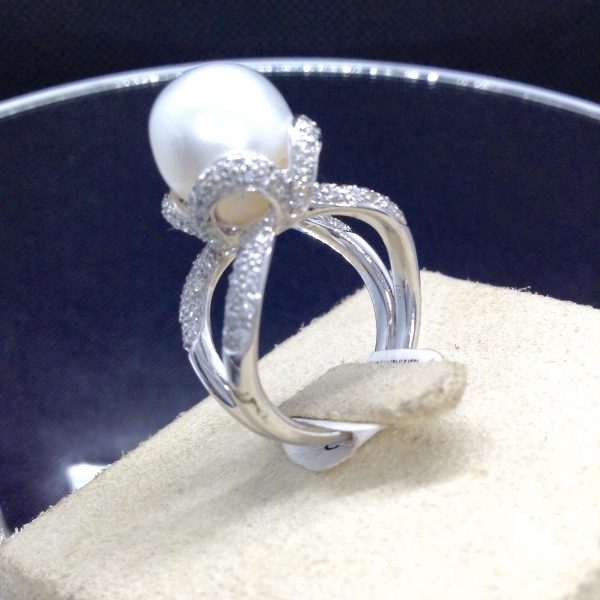 Side view of Stunning 18k White Gold Ring with a 12mm South Sea Pearl and 0.75 Ct Diamonds on a jewelry box