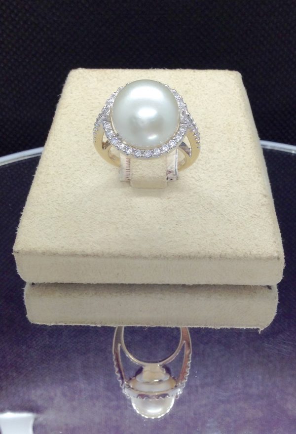 Front view of an Elegant 11mm South Sea Pearlwith 0.75 Ct Diamond 18k White Gold Cathedral Ring on a jewelry box