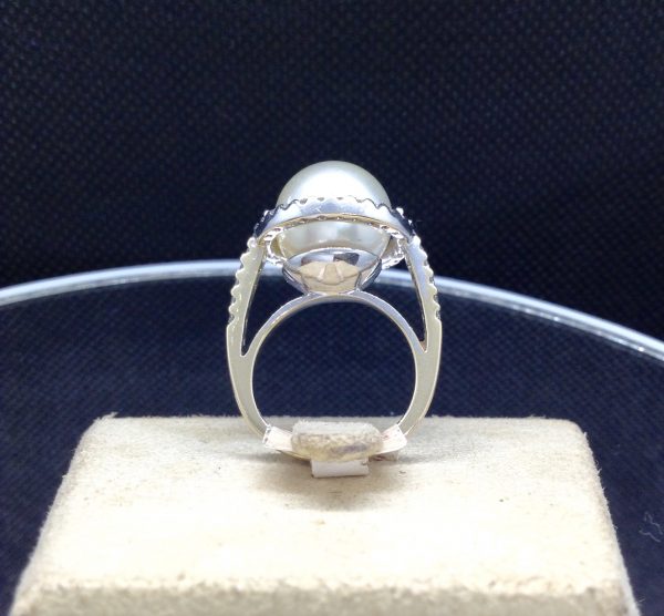 Elegant 11mm South Sea Pearlwith 0.75 Ct Diamond 18k White Gold Cathedral Ring on a jewelry box