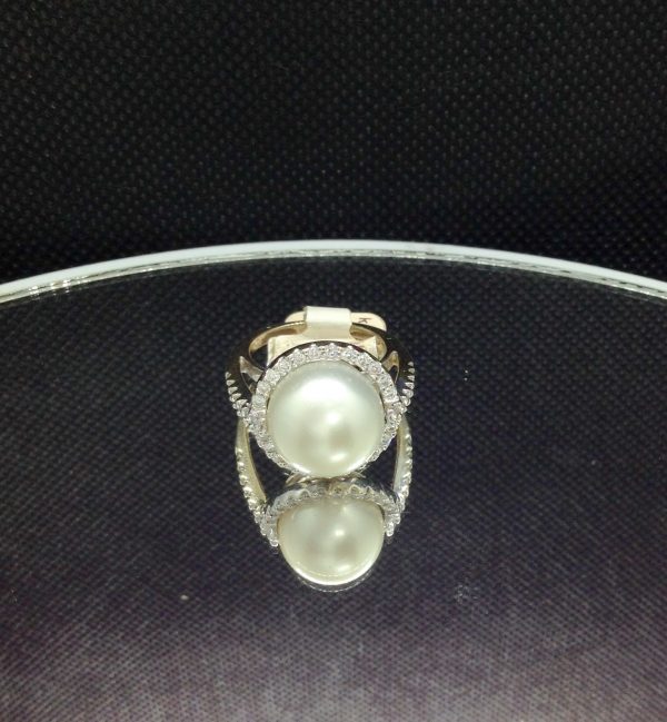 Elegant 11mm South Sea Pearlwith 0.75 Ct Diamond 18k White Gold Cathedral Ring on a piece of glass