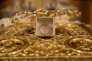 Two golden bracelets inside of a box, on top of a golden platform